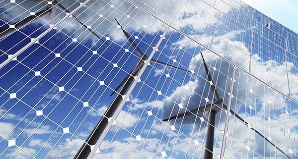 Wind turbines reflected in solar panels