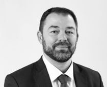 A person in a suit and tie
Description automatically generated